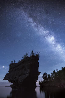 The Milky Way over a sea stack on stockton island in the apostle islands near bayfield wisconsin