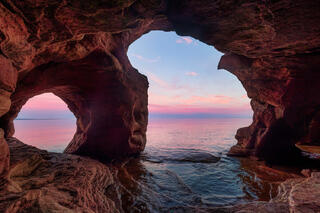 Devil's island sea cave with pastel colors at sunrise in the apostle islands in wisconsin