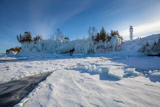 devil's island lighthouse with ice in the apostle islands national lakeshore on lake superior wisconsin.