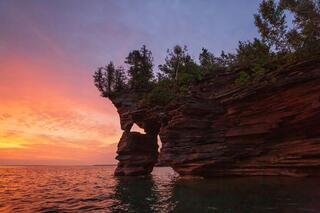 sandstone cliffs and sea caves at sunrise on devil's island