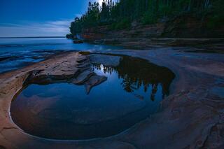 full moon rising on devil's island in the apostle islands national lakeshore