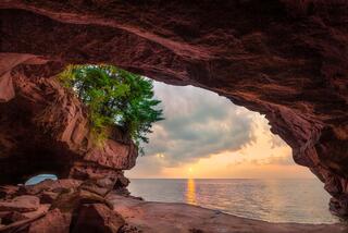 autumn sunrise on a chilly morning from a stockton island sea cave in the apostles