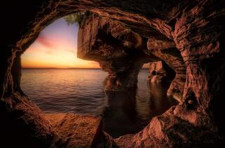 sunrise from inside a sea cave at sand island in the apostle islands national lakeshore on lake superior wisconsin
