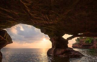 sunrise from inside a sea cave on stockton island in the apostles