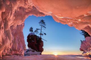 ice arch with frozen sea stack on stockton island in the apostle islands national lakeshore on lake superior wisconsin