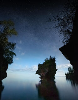 solitary sea stack on stockton island in the apostle islands under a moonlit sky