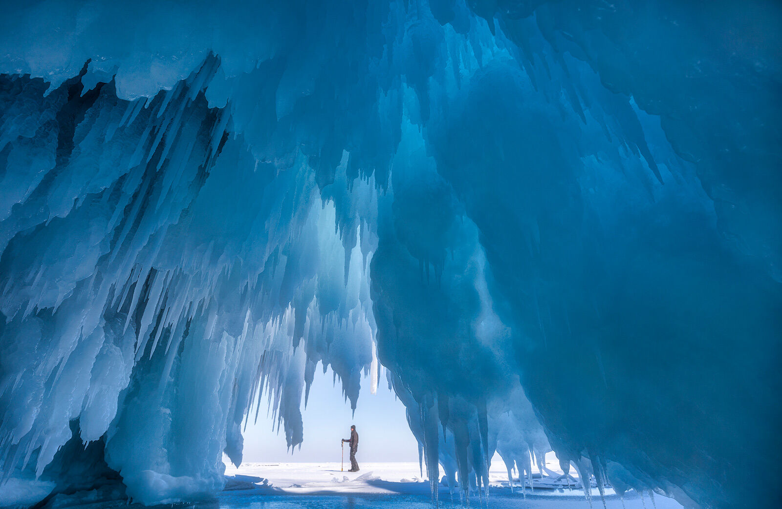 ice cave on cat island in the apostle islands with explorer in front