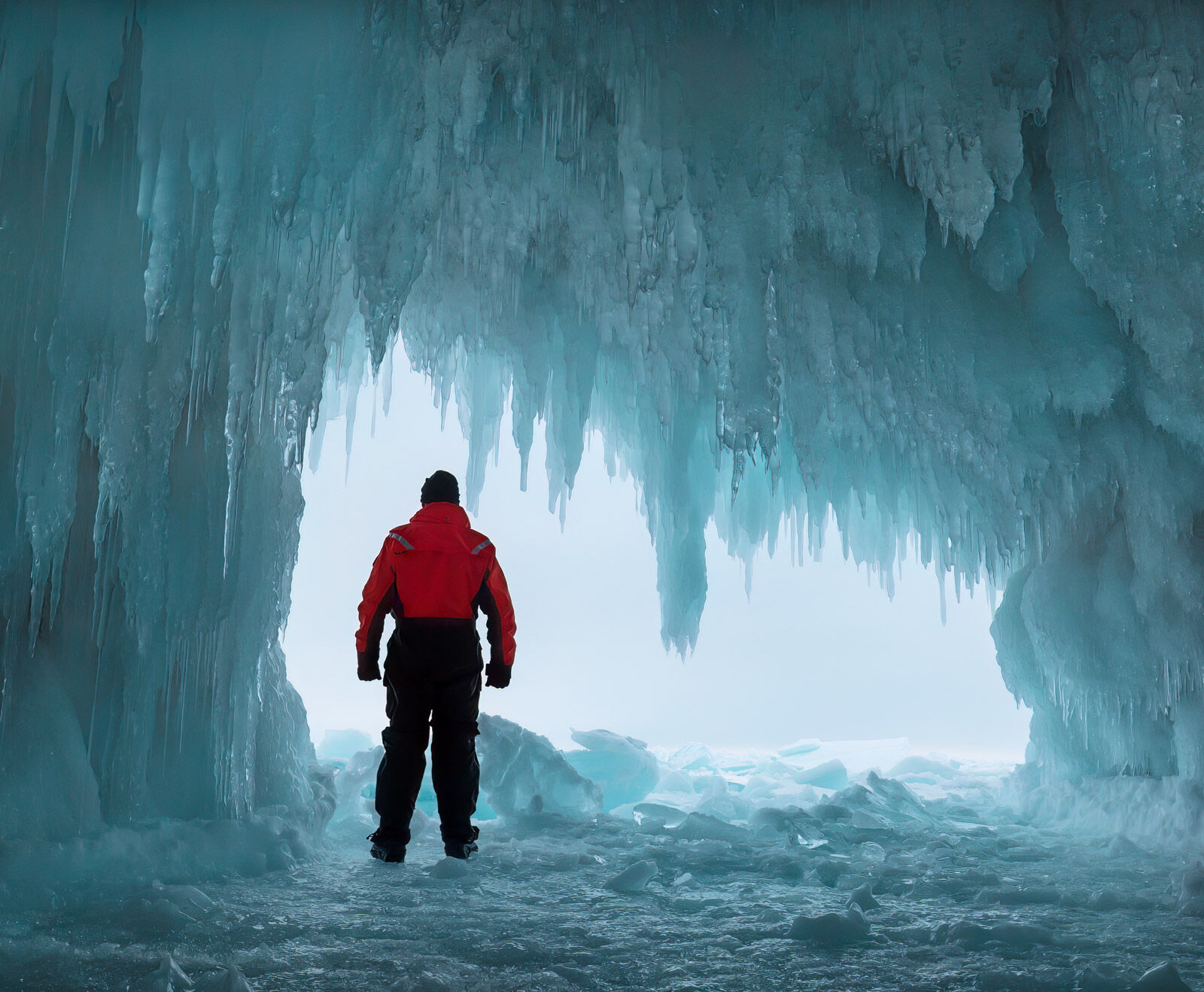 adventurer in an ice cave on devil's island in the apostle islands of wisconsin