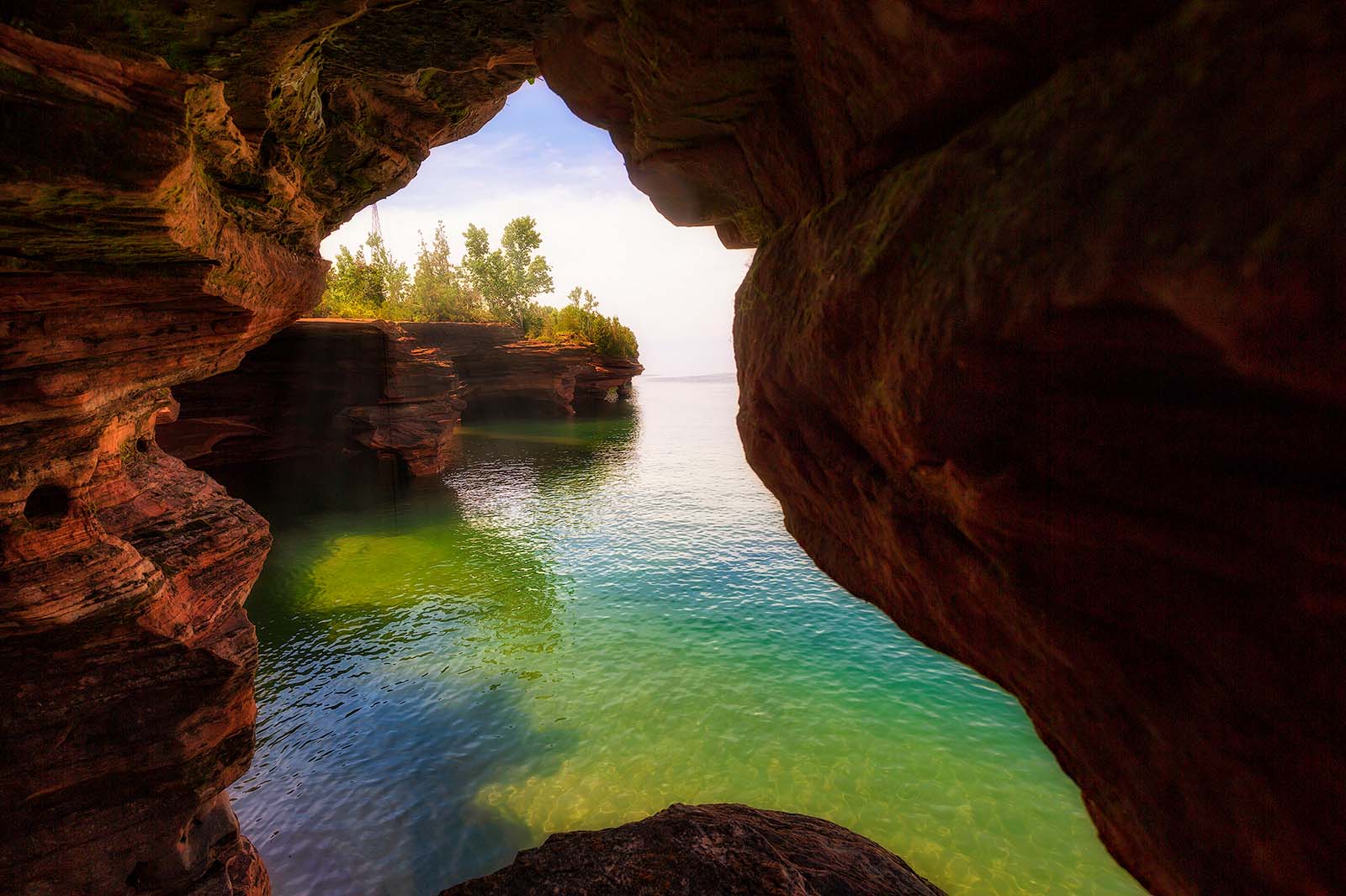 sandstone porthole and green water on devil's island in the apostle islands