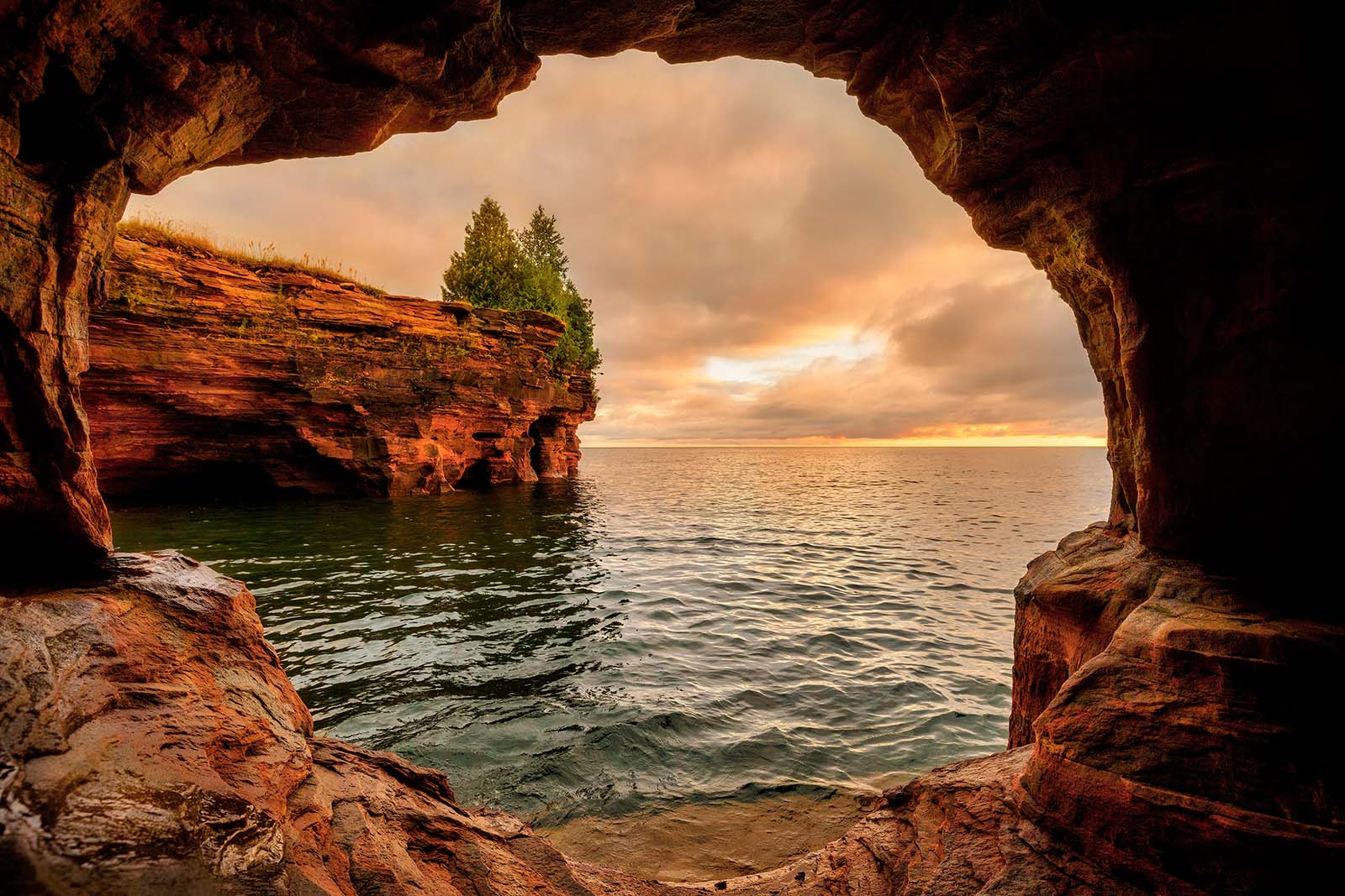 amazing devil's island sunrise from a sea cave in the apostle islands