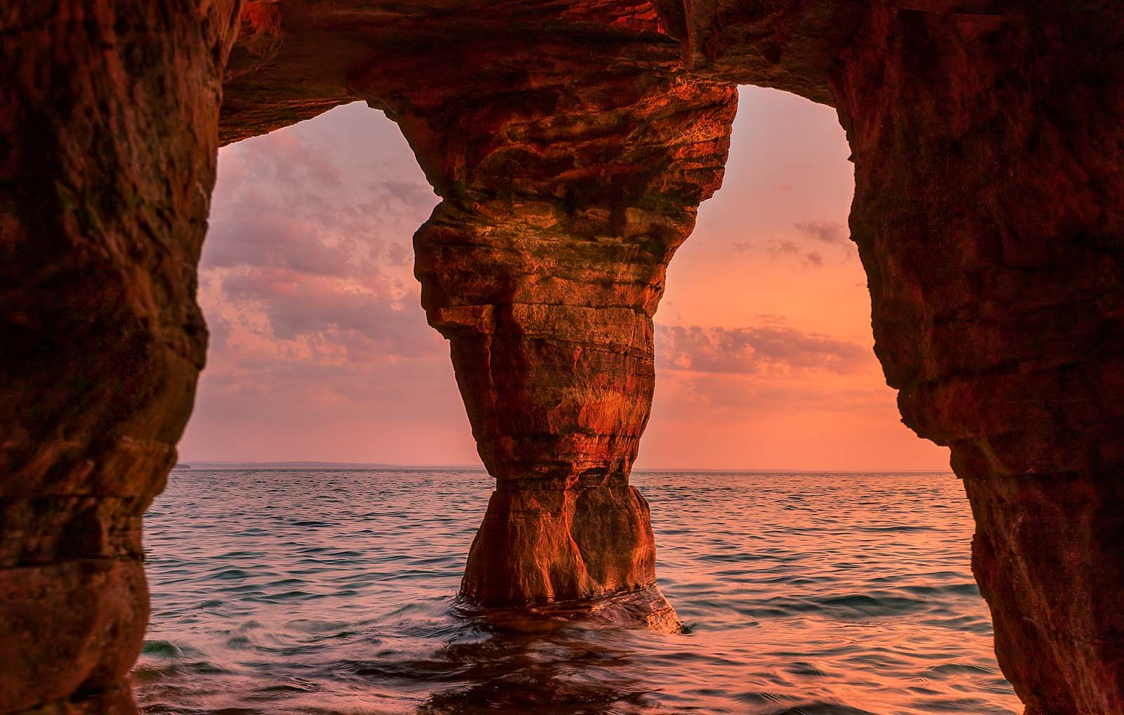sunset from a sea cave with pillar on devil's island in the apostle islands national lakeshore