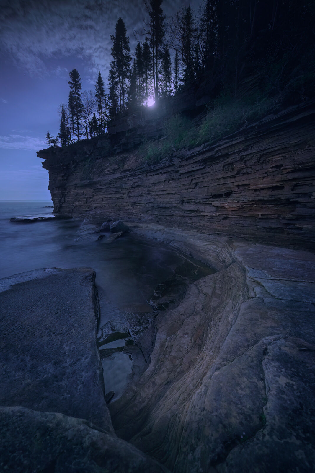 the rising moon lights the sandstone cliffs on devil's island