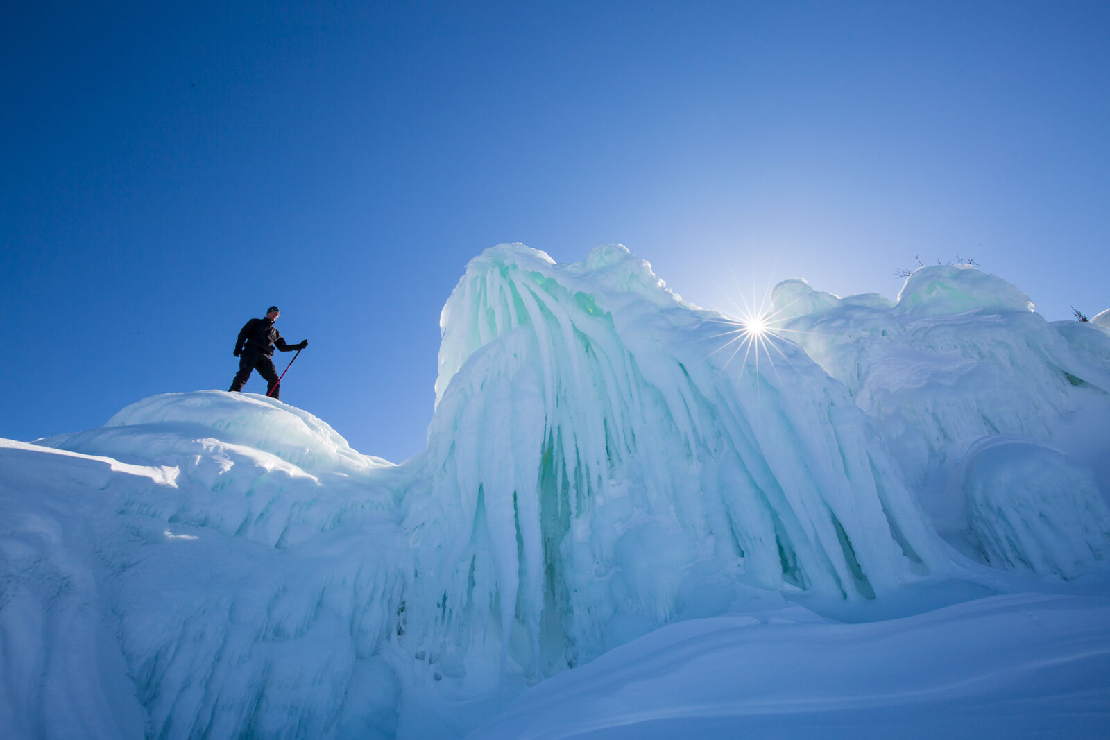 explorer standing on large ice formation in the apostle islands