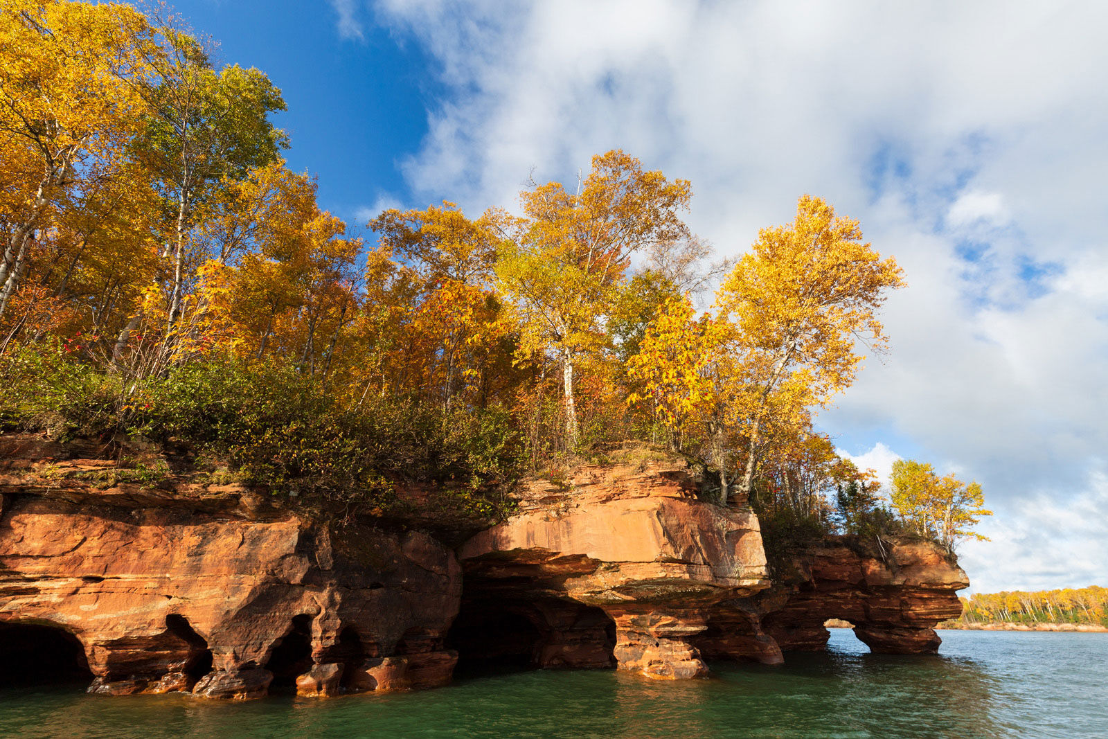 Peak fall colors at the swallow point sea caves on Sand Island in the Apostle Islands.