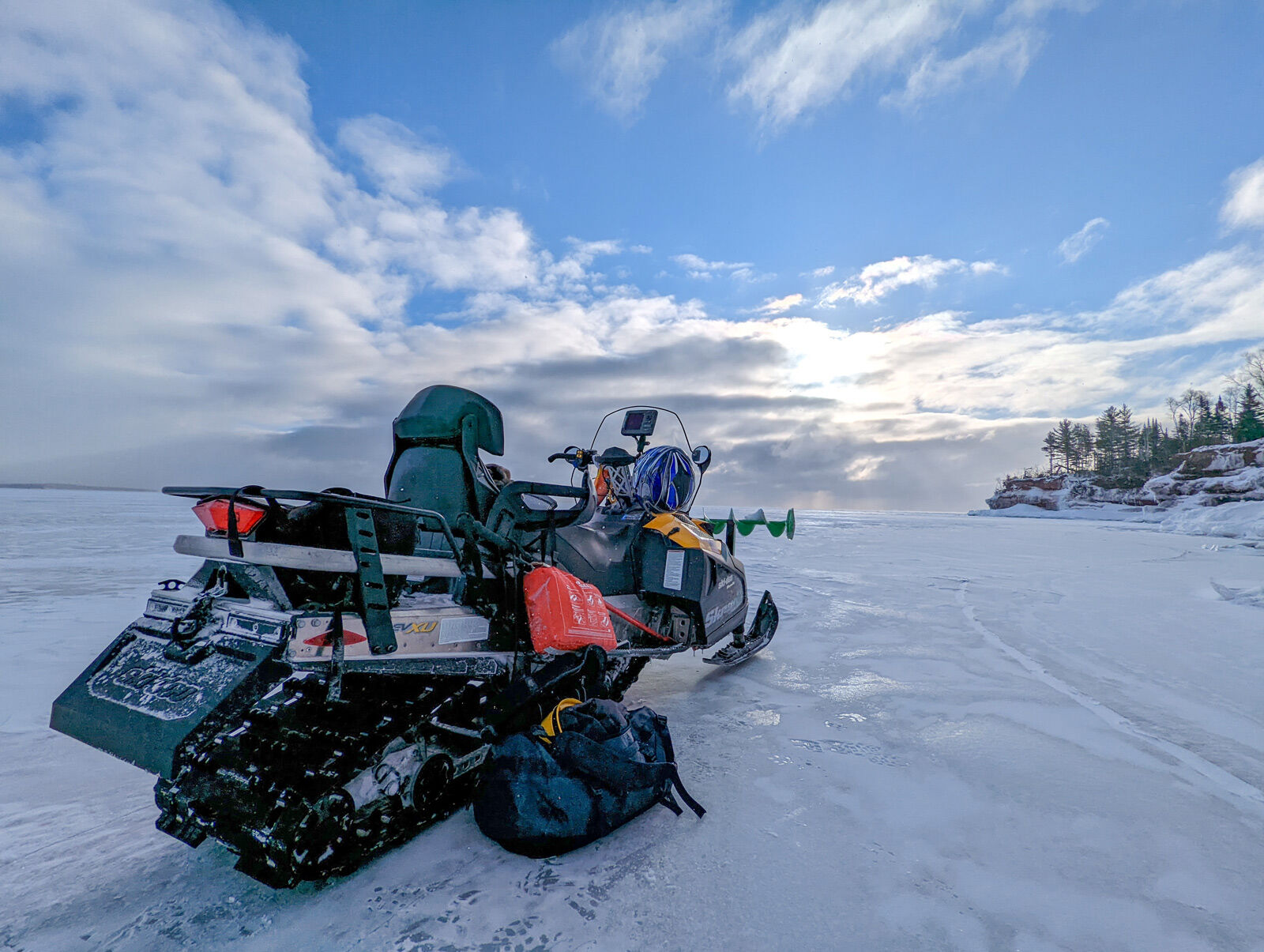 snowmobile with nebulous inflatable raft and safety gear on stockton island in the apostles
